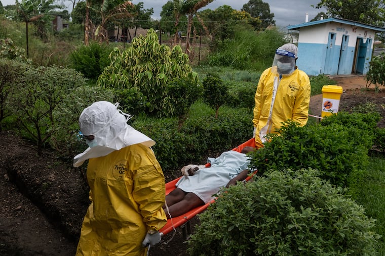Medical staff carry an Ebola patient to a treatment center in Rwampara, Congo, on Thursday.