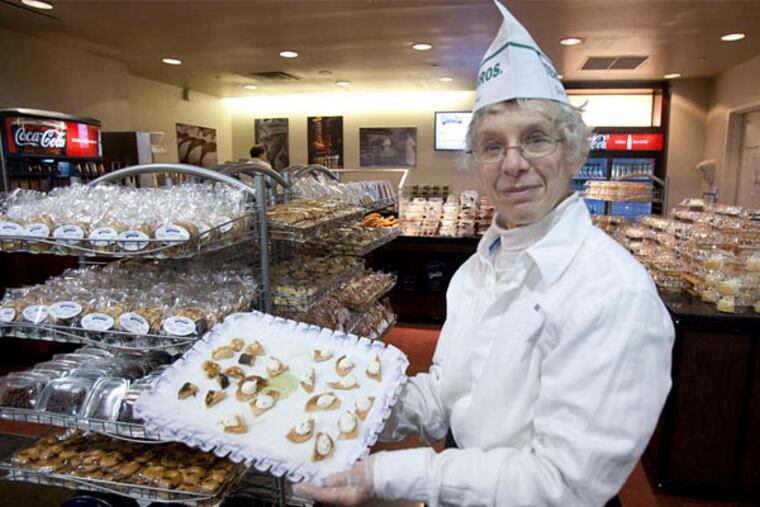 Better food: Susan Kafitz offers samples of chocolate chip cannolis at the Termini Brothers pastry stand at the Flower Show. (Ed Hille/Staff Photographer)