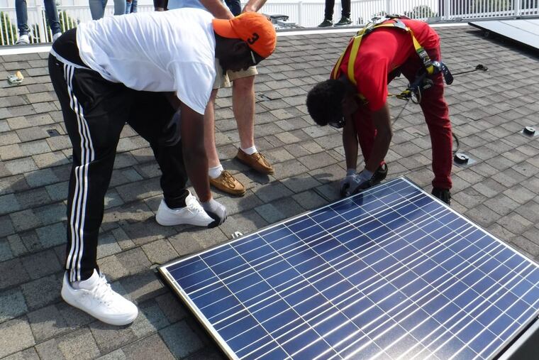 Students from the Philadelphia School District's first solar training program learn installation at the Navy Yard.