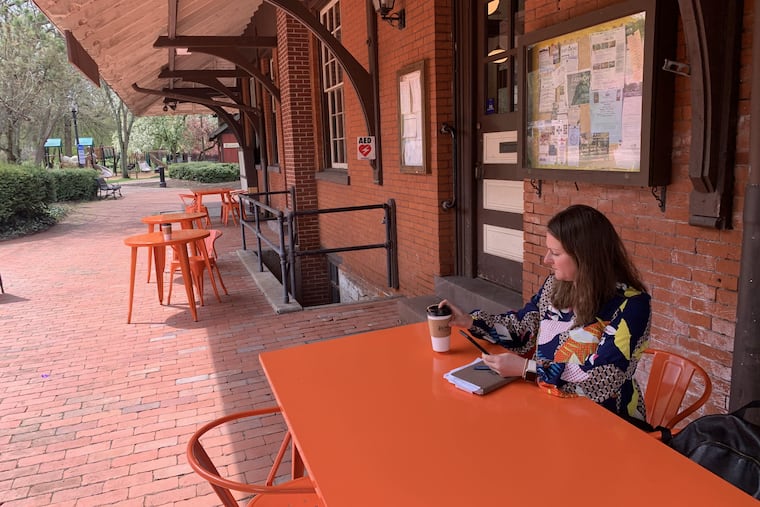 Jennilyn Schuster, main street manager for Downtown Bellefonte Inc. sits at the borough's outdoor working space in Talleyrand Park.