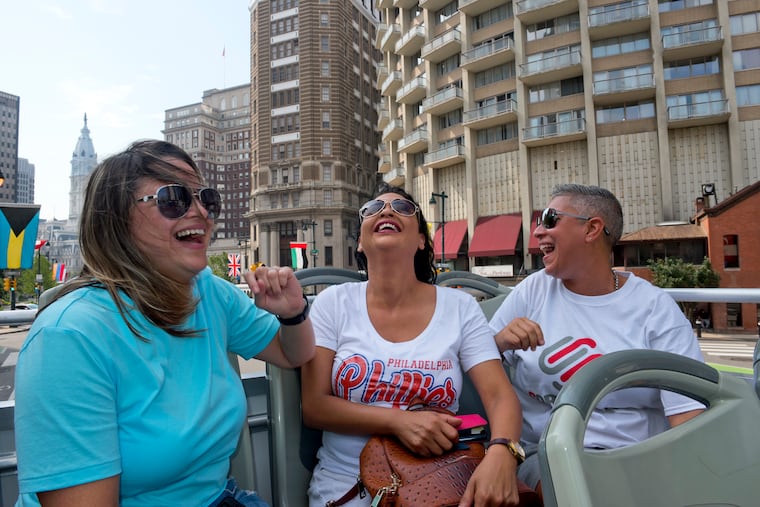 From left to right, Daisy Lopez, Carmen "Milly" Chevere Ortiz, and Soraida Perez, laugh while riding the Big Bus tour in Center City on August 6. In the aftermath of Hurricane Maria, Perez and Lopez met and forged a bond with Chevere Ortiz, a woman whose Puerto Rico neighborhood had been washed out by rising floodwaters. Nearly a year later, Chevere Ortiz visited Philadelphia, courtesy of Perez and Lopez.