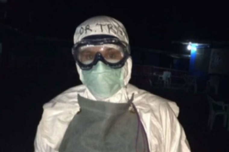 Henwood in the protective gear that prevented her use of a stethoscope, with the ultrasound machine she used to check patients instead.