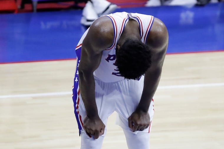 Sixers center Joel Embiid looks down waiting for the clock to end Game 7 against the Atlanta Hawks of the NBA Eastern Conference playoff semifinals.