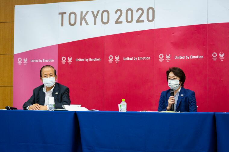Tokyo 2020 CEO Toshiro Muto (left) and President Seiko Hashimoto at a news conference after receiving a report from a group of infectious-disease experts on Friday.