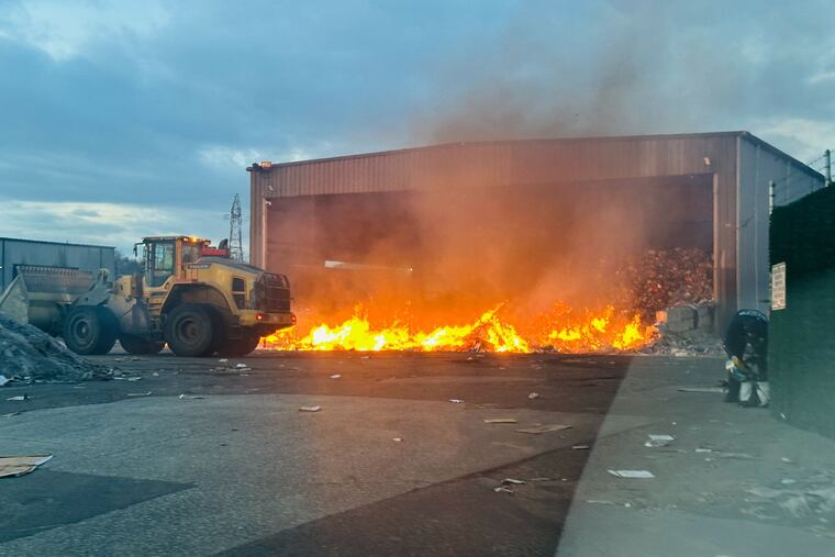 A fire produces smoke at the Waste Management Philadelphia Transfer Station on Grays Ferry Avenue on Thursday, Feb. 12, 2026, in Philadelphia. The city health department issued an advisory for nearby residents to stay inside due to potential air quality issues.