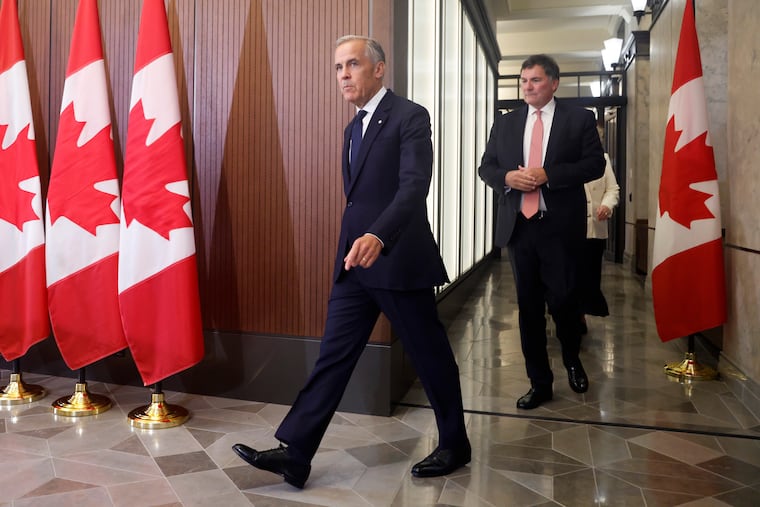 Prime Minister Mark Carney and Canada-U.S. Trade Minister Dominic LeBlanc arrive at a news conference about Canada's response to new U.S. tariffs on Parliament Hill in Ottawa on Saturday, Aug. 22, 2026.