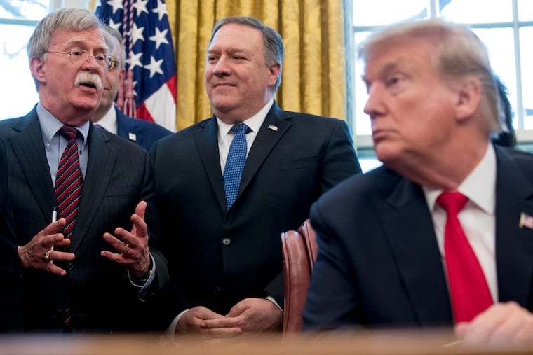 In this Feb. 7, 2019 file photo, from left, National Security Adviser John Bolton, accompanied by Secretary of State Mike Pompeo, and President Donald Trump, speaks before Trump signs a National Security Presidential Memorandum to launch the "Women's Global Development and Prosperity" Initiative in the Oval Office of the White House in Washington. Trump has fired national security adviser John Bolton.