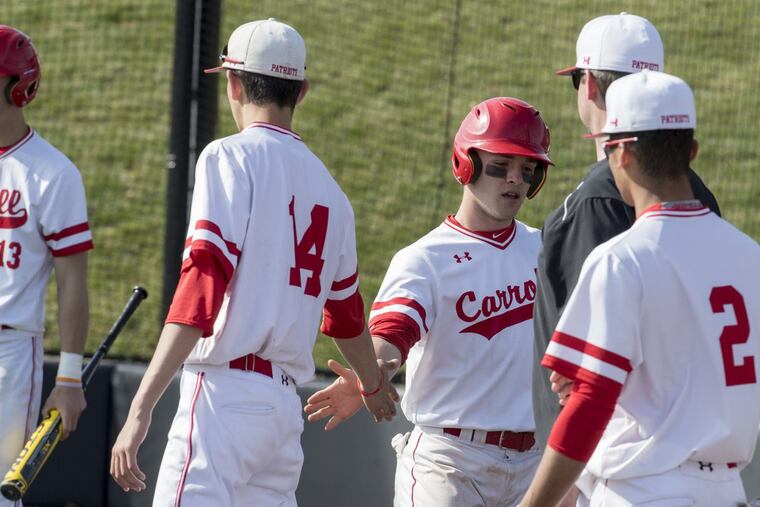 Archbishop Carroll’s Cole Chestnet gets high-fives from teammates earlier this season.