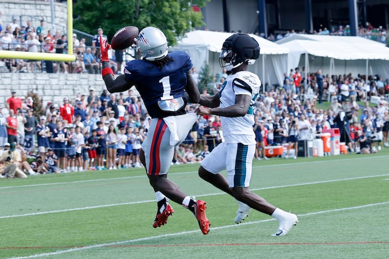 New England Patriots wide receiver A.J. Brown attempts to catch the football defended by Eagles cornerback Quinyon Mitchell on Wednesday.