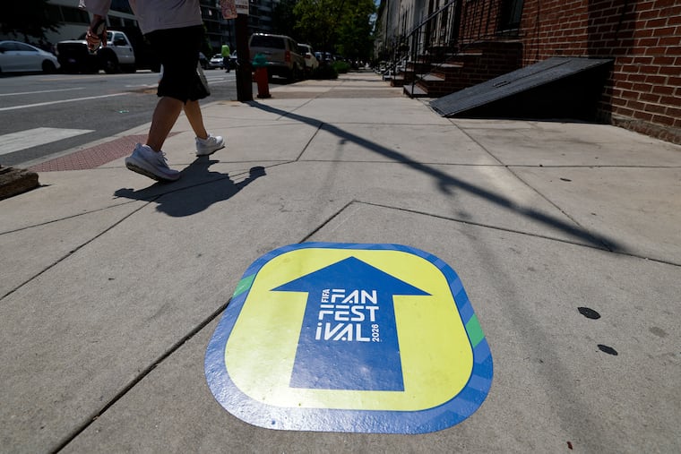 In Fairmount, a FIFA Fan Festival sidewalk sticker directs people to the event.
