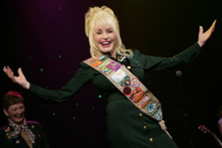 Dolly Parton, who was not a Scout, models new Girl Scout uniform.