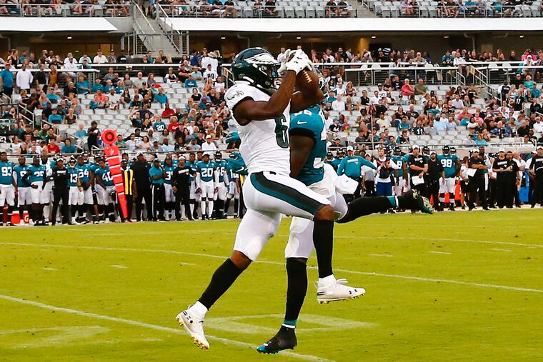 Eagles wide receiver Greg Ward catches the football past Jacksonville Jaguars defensive back C.J. Reavis during the second-quarter in a preseason game Thursday, August 15, 2019 in Jacksonville. Ward scored on the play.