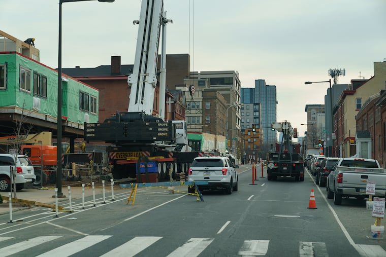 A crane in the lefthand lane on Chestnut Street between 41st and 42nd Streets, as seen from the 21 bus, in Philadelphia in December.