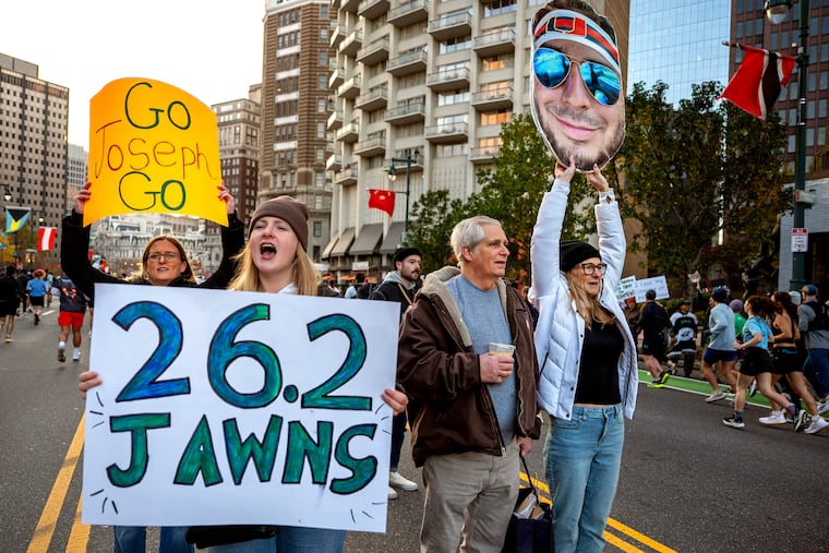 The family of Joseph Maroon, of Miami, Fla. running in his first marathon, cheer him and the other runners along. From left are his wife, Erin Smith; sister-in-law Kiara Smith; and father and mother in- law Bob and Susan Smith, all from River Vale in Bergen County, N.J.