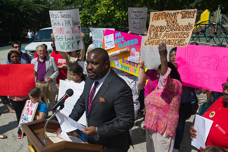 Philadelphia City Councilor Kenyatta Johnson leads a rally for state funding for Philly schools with parents, students and district teachers at the playground of Greenfield Elementary School in center city Aug. 5, 2014. ( CLEM MURRAY / Staff Photographer )