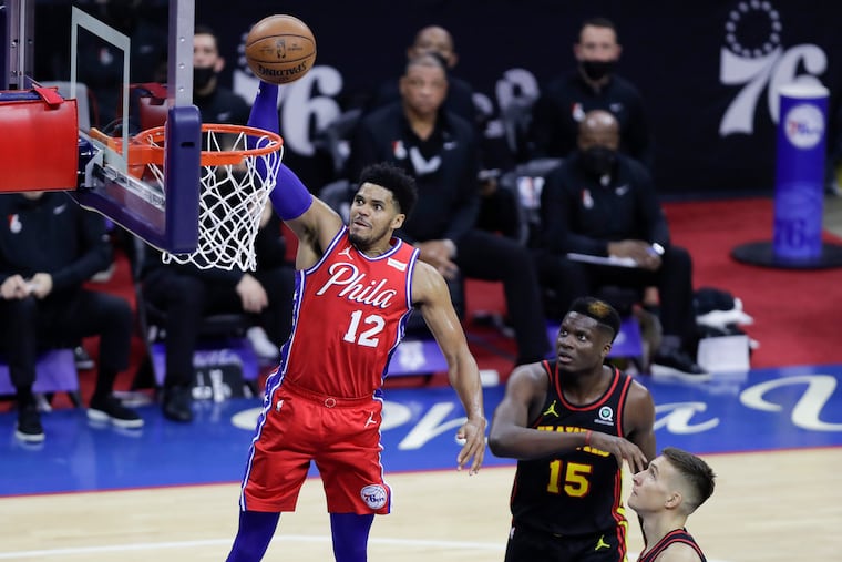 Sixers forward Tobias Harris dunks in Sunday's Game 1 as Hawks center Clint Capela (center) and guard Bogdan Bogdanovic watch.