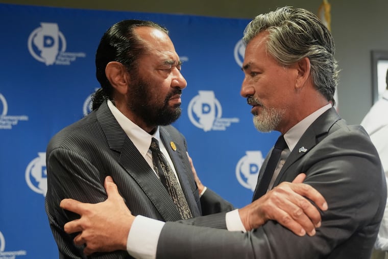 U.S. Rep. Al Green (left) and State Rep. Ramon Romero Jr., both of Texas, talk after Democratic Texas legislators gave a news conference in Aurora, Ill., on Tuesday, explaining their effort to thwart a Republican gerrymandering plan prompted by President Donald Trump.