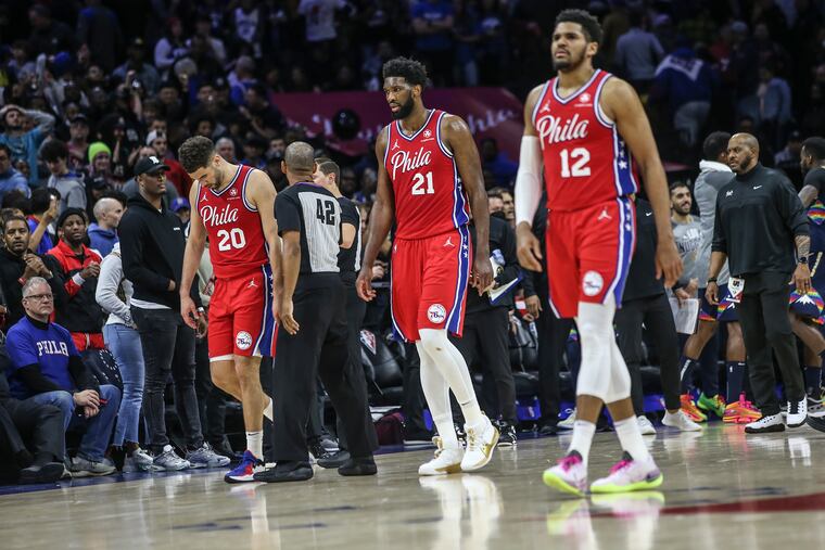Sixers Georges Niang (20), Joel Embiid (21) and Tobias Harris walk off the court after Monday's 114-110 loss to the Denver Nuggets.