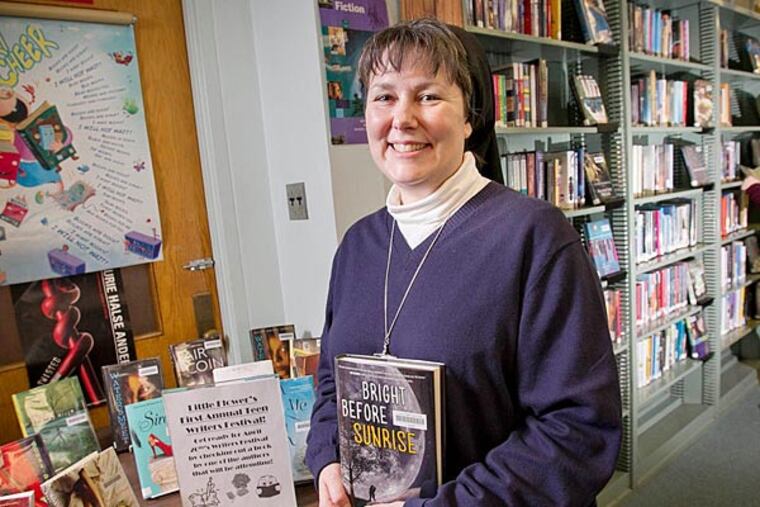 Sister Kimberly Miller of Little Flower H.S. is organizing its 1st Little Flower Teen Author Festival. She's seen here on Thursday, Feb. 20, 2014 in the school library with display of books written by young authors who will attend the festival. ( ALEJANDRO A. ALVAREZ / STAFF PHOTOGRAPHER )