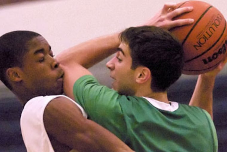 Timber Creek's Mikel Demby takes an elbow, but not the charge he was trying for, from Camden Catholic's Anthony D'Orazio. D'Orazio scored 10 of his 13 points in the second half as The Inquirer's top-ranked team prevailed at home, 65-53. (John Costello / Staff Photographer)