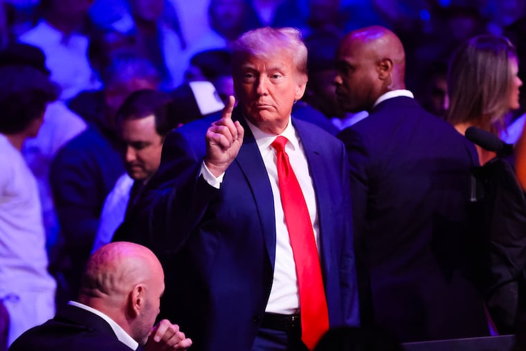 President Donald Trump makes an appearance during a UFC mixed martial arts event in Las Vegas earlier this month. The former president's lawyers claim he is too busy campaigning to be put on trial.