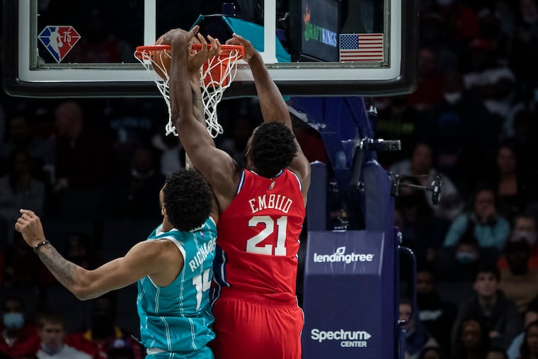 Sixers center Joel Embiid (21) dunks over Charlotte Hornets center Nick Richards (14) during the first half of Wednesday's game.