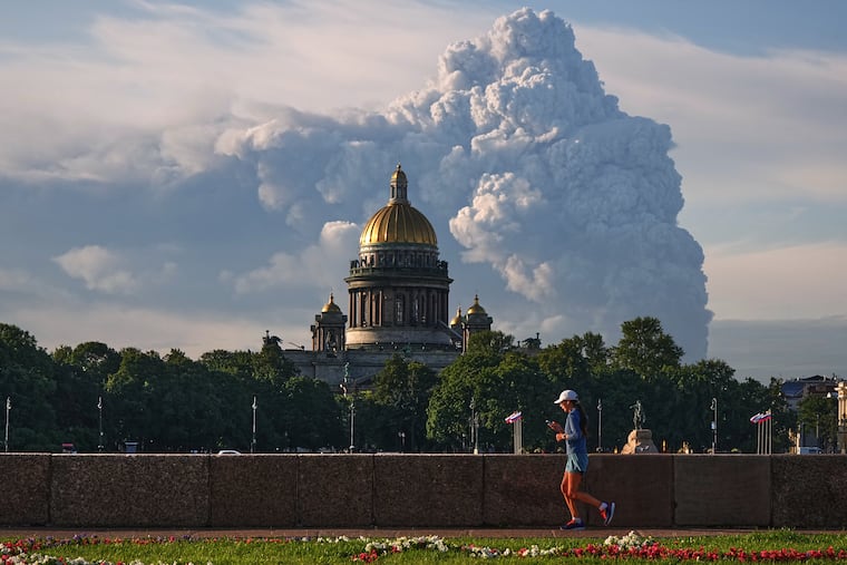 Smoke billows into the sky following Ukrainian drone strikes on warehouses of Russia's online retailer Wildberries, in St. Petersburg, Russia, Friday, July 24, 2026, with St. Isaac's Cathedral seen in foreground.
