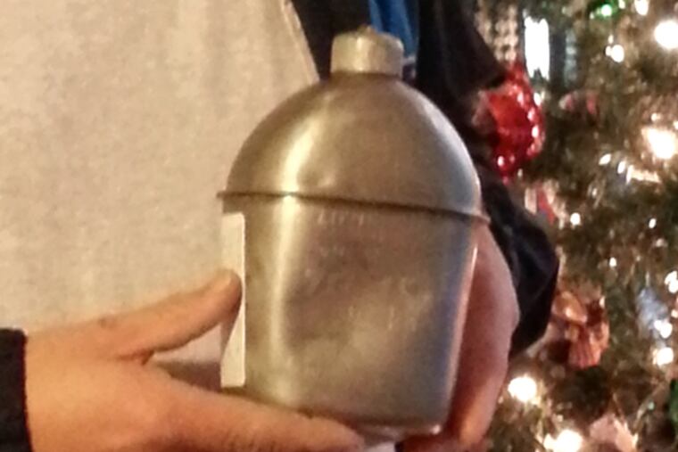 Ted Nobles, of Middletown, Del., holding his great uncle Lt. Wallace Lippincott's canteen.(Elizabeth Robertson/Staff photographer)