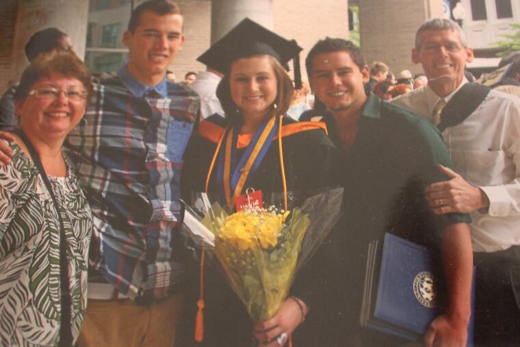 Emily Fredricks, shown with her family after graduating from college, was struck and killed by a garbage truck while riding her bicycle in 2017.