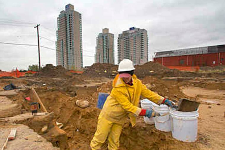 Archaeologist Joelle Browning collects artifacts from the SugarHouse site. A state historical official said the casino has gone "well beyond a good-faith effort" in researching the area. (Ed Hille / Staff)