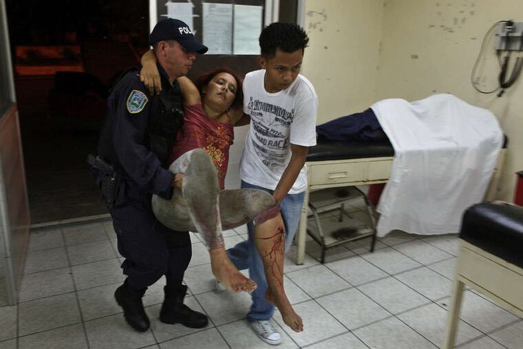 at a pool-hall shooting is carried into an emergency room at Catalino Rivas Public Hospital in San Pedro Sula, Honduras. ESTEBAN FELIX / Associated Press, File