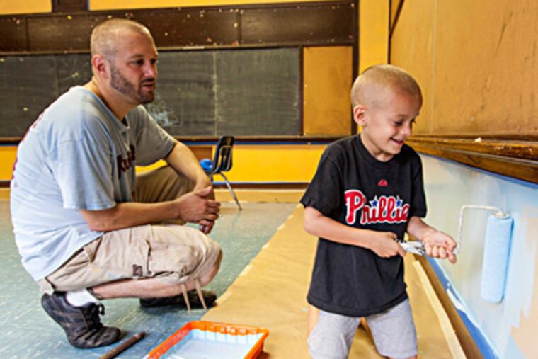 Mark Scott and son Henry at E.M. Stanton Elementary, where Henry will start this year. ELISE WRABETZ / Staff Photographer
