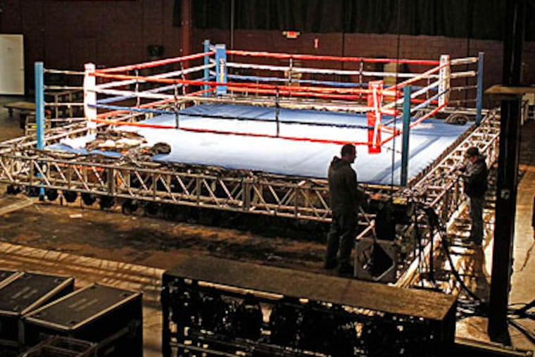 Workers set up for the premiere of "Fight Night" on the NBC Sports Network. (Akira Suwa/Staff Photographer)