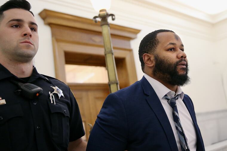 Deputies bring Keenan Jones, right, to a courtroom at the Montgomery County Courthouse in Norristown. Jones is accused of firing a gun "indiscriminately" inside a crowded Walmart in August 2018, wounding five people.