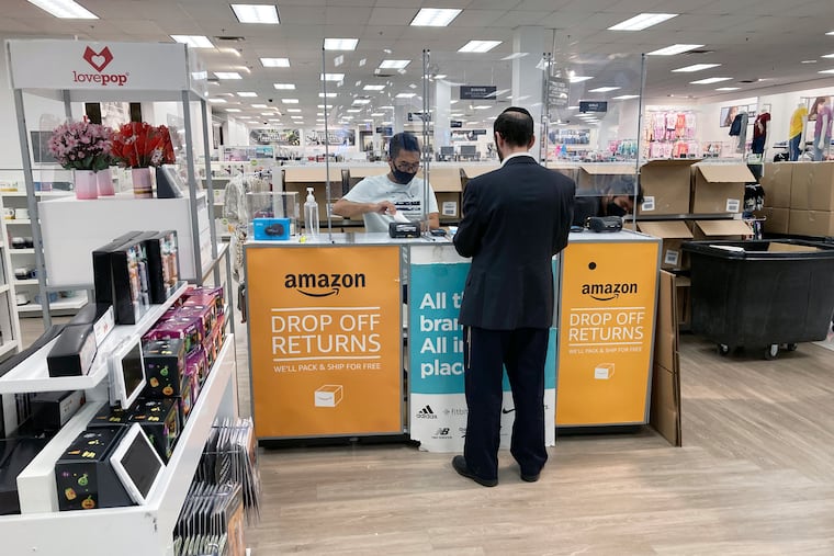 A man returns items purchased online at an Amazon counter inside a Kohl's department store in Clifton, N.J., on Sept. 3, 2021. Amazon, which industry experts say has engaged in the practice for years, announced in August that it would extend returnless refund options to its third-party sellers.