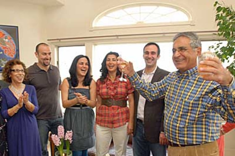 Fiances Hava Tabari, center, and Raziel Ungar, second from right, look on with friends and family as Keyvan Tabari, father of the future bride, explains the symbols of the Persian New Year during a gathering in Nicasio, Calif. (Sherry LaVars/Contra Costa Times/MCT)