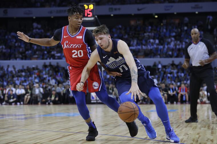 Markelle Fultz guards Luka Doncic of the Dallas Mavericks, right, in the preseason game against the Mavericks.