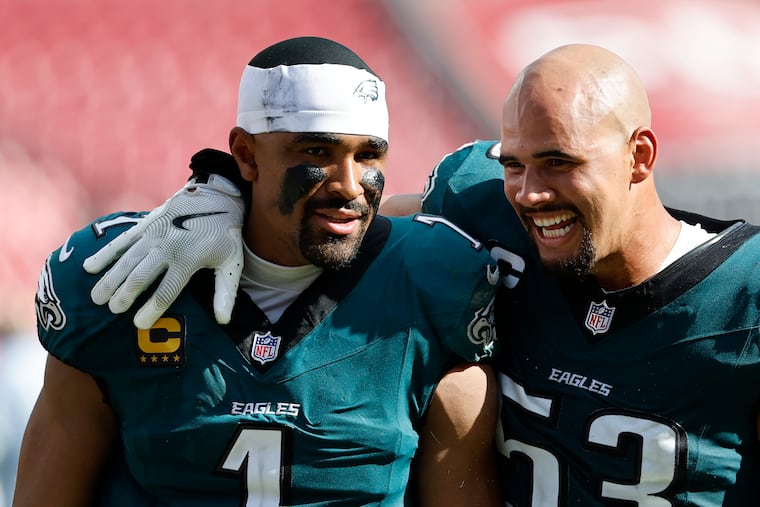 Linebacker Zack Baun (right) walks off the field with his much more famous teammate, Jalen Hurts, after beating the Tampa Bay Buccaneers on Sept. 28.