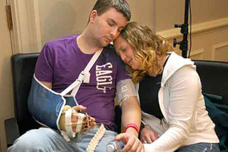 Joshua Maloney, 24, of Bethel Park, Pa., who received a hand transplant in March at the University of Pittsburgh Medical Center, relaxed with girlfriend Erin Maxa after a news conference last week. Maloney lost his right hand two years ago in a training accident at the Quantico, Va., Marine Corps base.