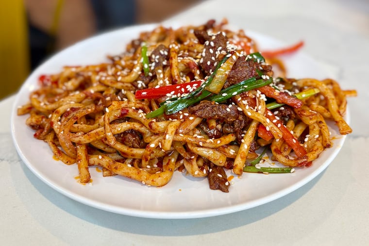 Chewy hand-pulled lagman noodles stir fried with beef, peppers and chili sauce are the signature specialty at Uyghur Noodle King in University City.