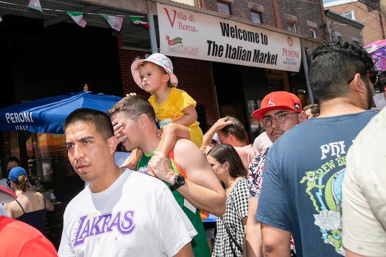 People navigate a packed street at the South 9th Street Italian Market Festival in Philadelphia on Saturday. It wasn't the Fourth of July. It just felt like it, on the street, and in the air.