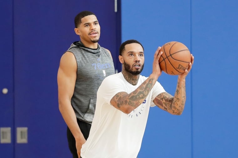 Sixers forward Mike Scott shoots the basketball as teammate forward Tobias Harris watches during practice at the 76ers training complex in Camden on Thursday, October 10, 2019.