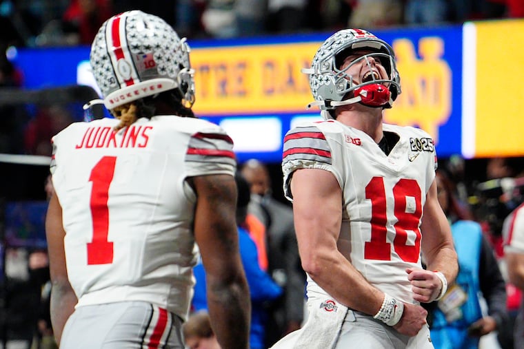 Ohio State quarterback Will Howard celebrates after a touchdown by running back Quinshon Judkins during second half of the College Football Playoff national championship game against Notre Dame.