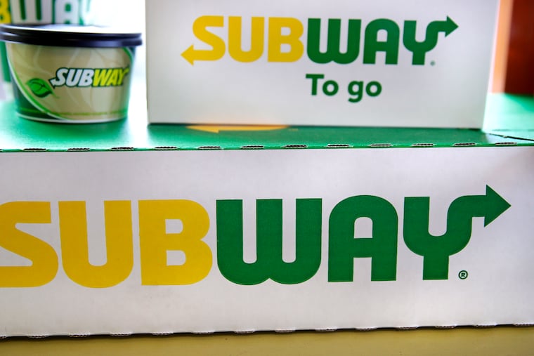 The Subway logo is seen on takeout boxes at a restaurant in Londonderry, N.H., in 2018.