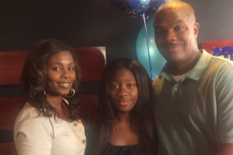 Kayla Ryder, 13, of Aston, Pa., is flanked by her mother Sakina Ryder and father Donald Ryder.
