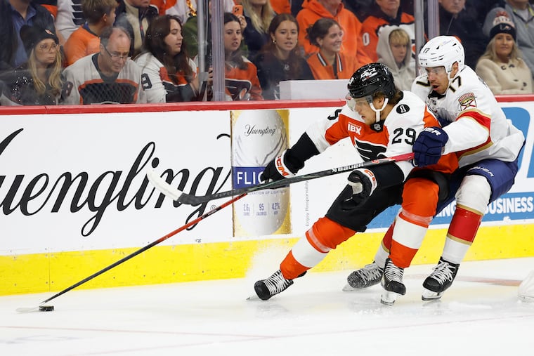Flyers winger Nikita Grebenkin (left) skates after the puck with Florida's Evan Rodrigues in pursuit on Monday.