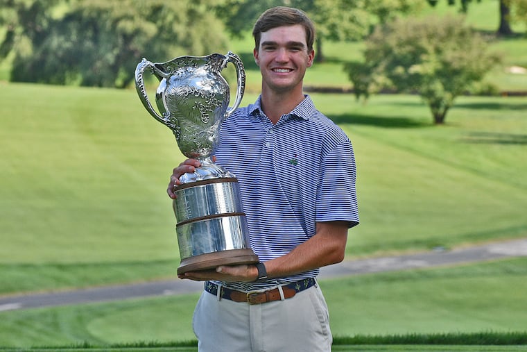 2021 Patterson Cup champion Peter Bradbeer holds the winner's trophy.