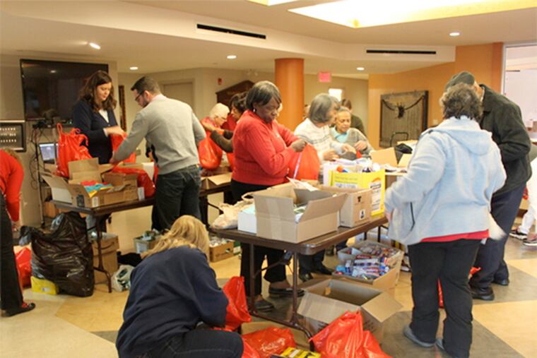 Volunteers pack "ditty bags" filled with gifts that were to be distributed to seamen aboard ships docked in the Delaware River. The annual event was canceled after a tugboat set to be used to deliver the bags was vandalized.