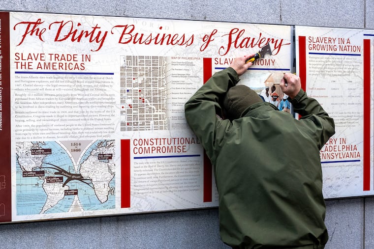 A NPS worker removes an interpretive panels - “The Dirty Business of Slavery” - at the President’s House site in Independence National Historical Park Thursday, Jan. 22, 2026. More than a dozen educational displays and illustrations about slavery were removed from the site, which serves as a memorial to the nine people George Washington enslaved there during the founding of America. President Trump’s executive order, “Restoring Truth and Sanity to American History," directed over 400 national sites to remove or modify interpretive materials that "inappropriately disparage Americans past or living.”