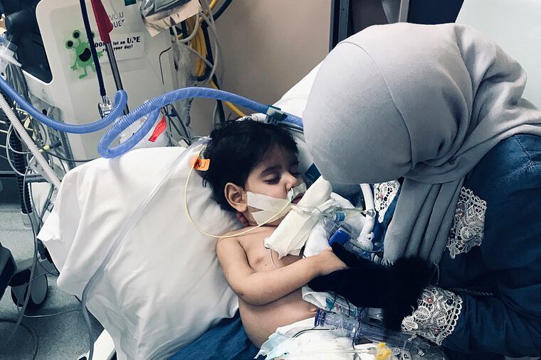 In this Wednesday, Dec. 19, 2018, photo released by the Council on American-Islamic Relations, Sacramento Valley, Shaima Swileh holds her dying 2-year-old son Abdullah at a hospital in Oakland, Calif. Swileh, a Yemeni mother who fought for the right to see her dying son, arrived Wednesday night after the Trump administration gave her a long-sought waiver to its travel ban. (Council on American-Islamic Relations, Sacramento Valley via AP)